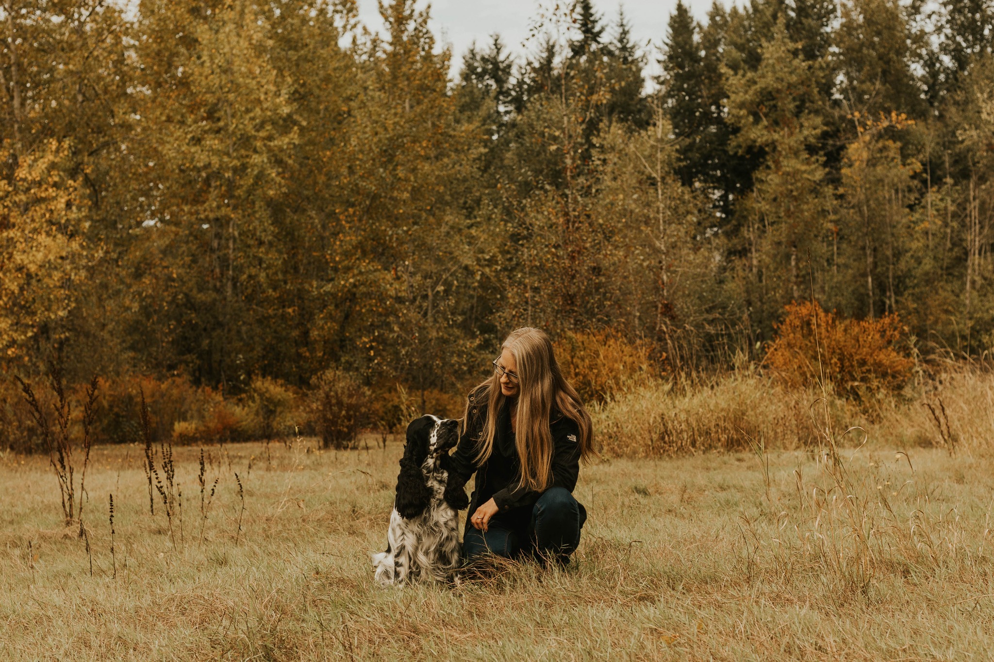 Woman with her English Springer Spaniel outdoors